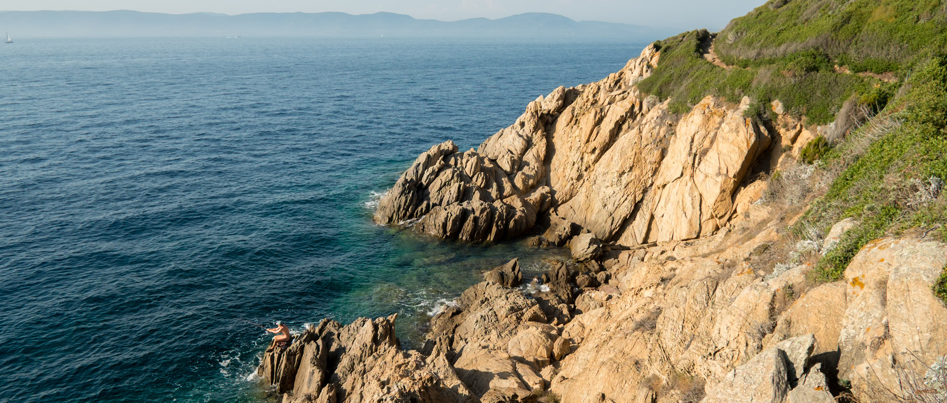 Pêcheur sur un rocher, à l'île du Levant.